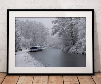 Snow-covered trees line the frozen Macclesfield Canal, Peak District