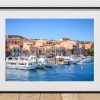 The harbour at La Maddalena is filled with small boats, clear blue water, Peak District