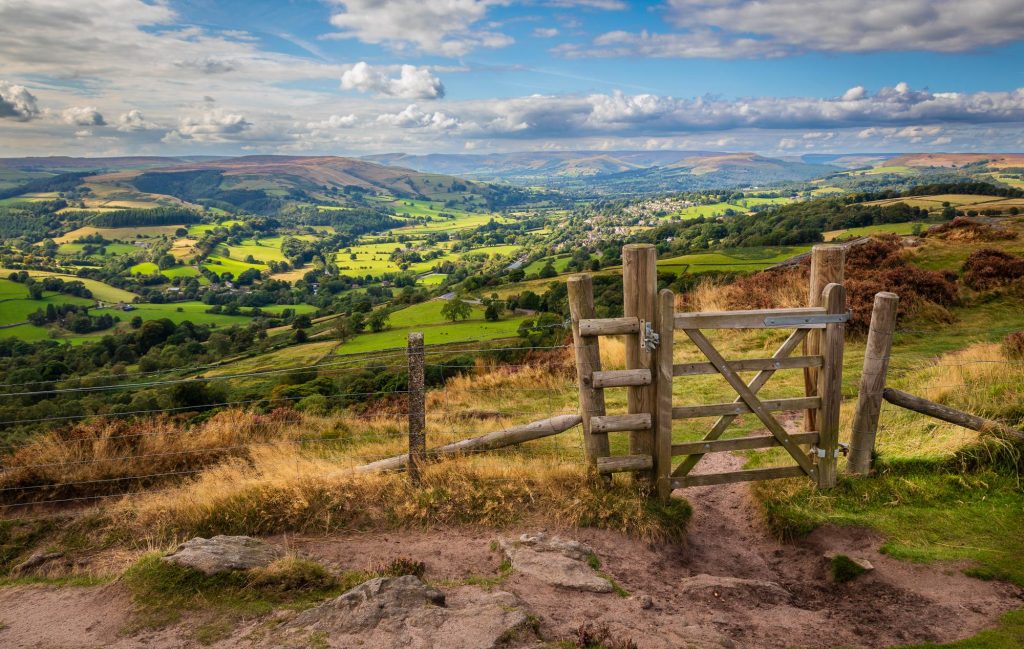 A small green gate stands above Millstone Edge, Peak District – view 2