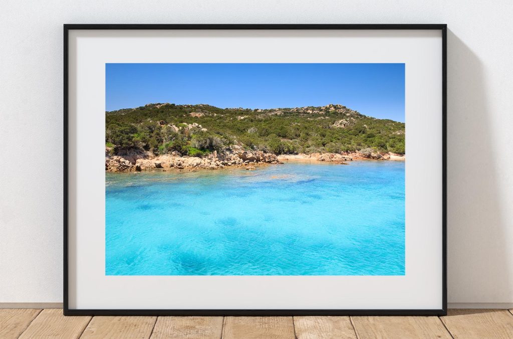 Clear turquoise water meets a sweep of pale sand at Isola de Spargi in the Maddalena Archipelago