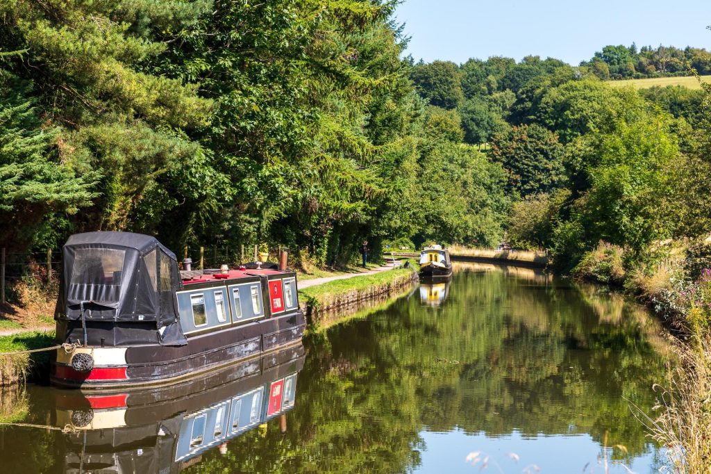 A narrowboat rests beside the Macclesfield Canal at Sutton, Peak District – view 2