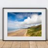 Rhossili Beach is captured beneath dramatic clouds in late summer light on the Gower Peninsula
