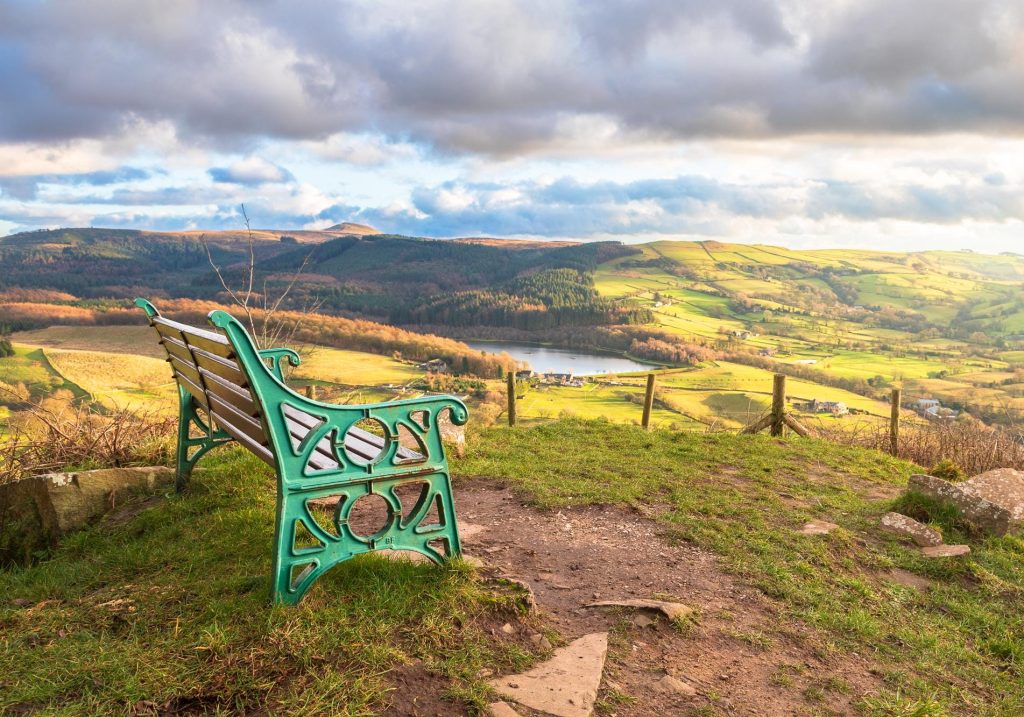A familiar seat at the top of Teggs Nose Country Park looks across Macclesfield Forest towards Shutlingsloe – view 2