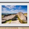 Weathered gritstone forms the foreground at Owler Tor, Peak District