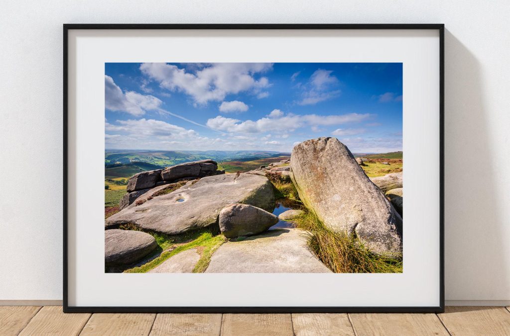 Weathered gritstone forms the foreground at Owler Tor, Peak District