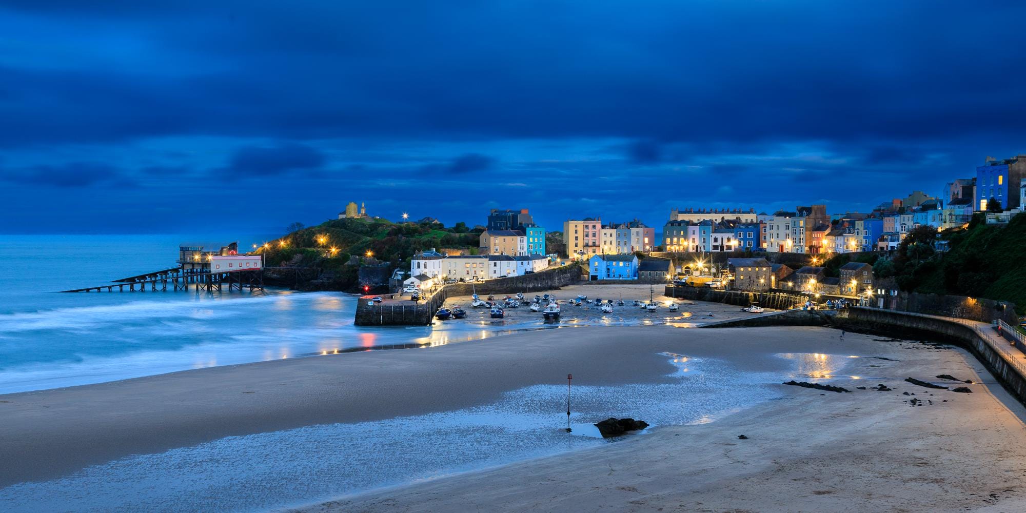 Tenby Harbour is captured here during the blue hour after sunset, Wales – view 2