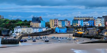 Tenby Harbour is seen in a broad panoramic view just before sunset, Wales
