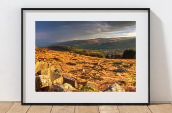Evening sunlight falls across Carshead Rocks, looking towards Hathersage, Peak District