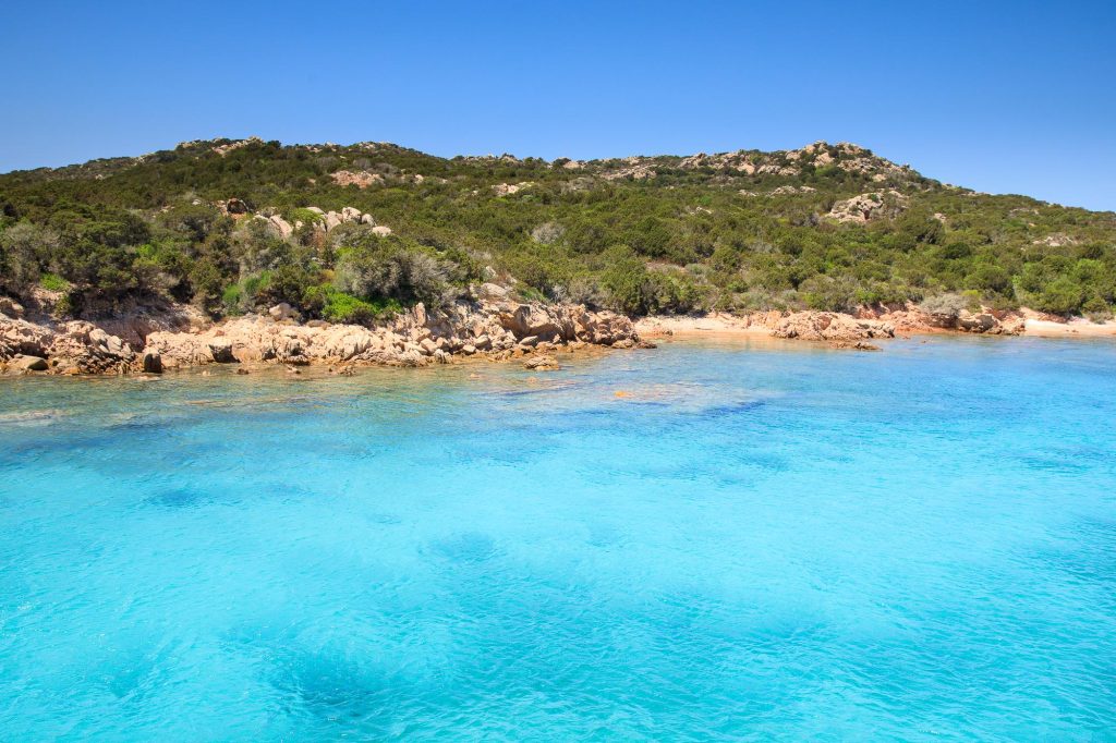 Clear turquoise water meets a sweep of pale sand at Isola de Spargi in the Maddalena Archipelago – view 2