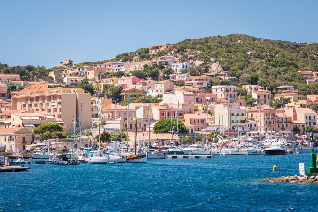 The harbour of La Maddalena is filled with boats in this bright coastal view of the town on the island of Maddalena – view 2