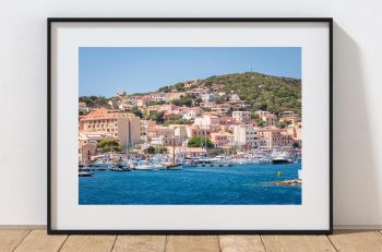 The harbour of La Maddalena is filled with boats in this bright coastal view of the town on the island of Maddalena