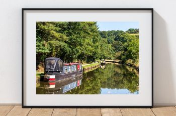 A narrowboat rests beside the Macclesfield Canal at Sutton, Peak District