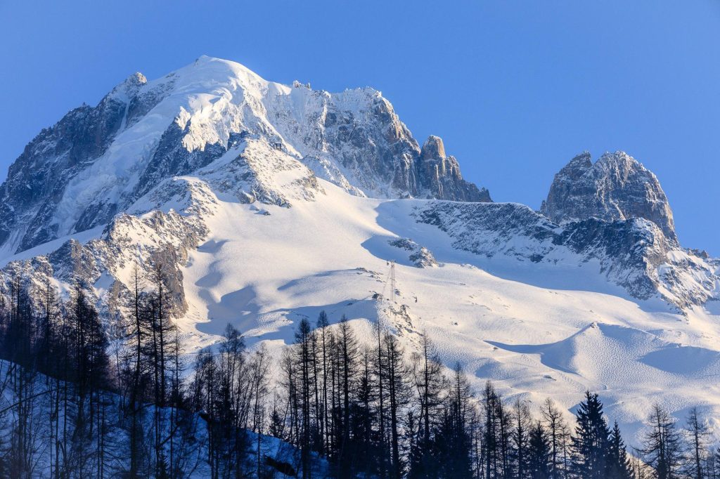 The Grand Montets and Aiguille Verte rise above Argentière in a crisp winter view of the Chamonix valley, France – view 2