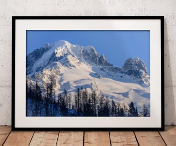 The Grand Montets and Aiguille Verte rise above Argentière in a crisp winter view of the Chamonix valley, France