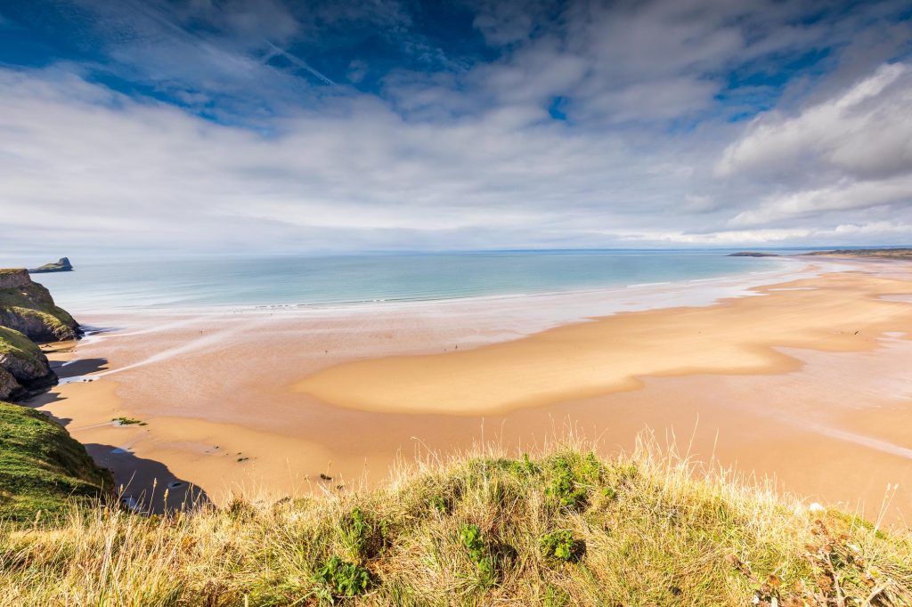 Rhossili Beach stretches along the Gower coast beneath a changing sky – view 2