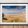 Rhossili Beach stretches along the Gower coast beneath a changing sky
