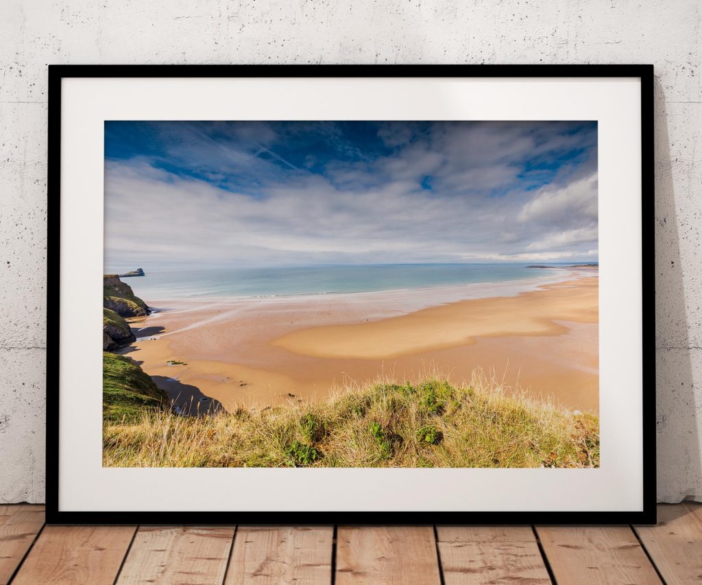 Rhossili Beach stretches along the Gower coast beneath a changing sky
