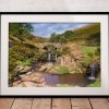 The packhorse bridge at Three Shires Head spans a small pool between waterfalls in the Peak District