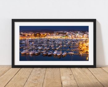 As evening settles over Vilamoura Marina, the harbour lights begin to glow among the moored boats