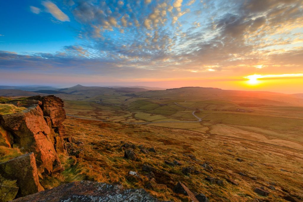 The setting sun spreads warm light across the high ground around Shining Tor, Peak District – view 2