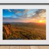 The setting sun spreads warm light across the high ground around Shining Tor, Peak District