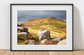 Autumn sunlight breaks across the moors above Hathersage, Peak District