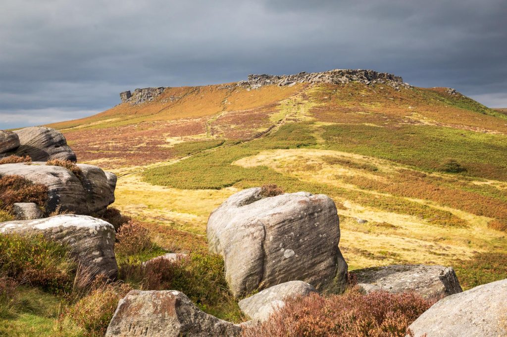 Autumn sunlight breaks across the moors above Hathersage, Peak District – view 2