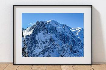 Snow-covered summits rise above the Chamonix valley in this winter view from the high slopes of the French Alps, France