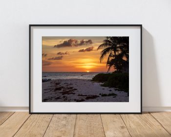 The sun slips towards the horizon over Hastings Beach in Barbados