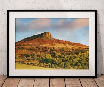 Roseberry Topping rises above the North York Moors in a rich autumn landscape of russet heather, bracken, Yorkshire