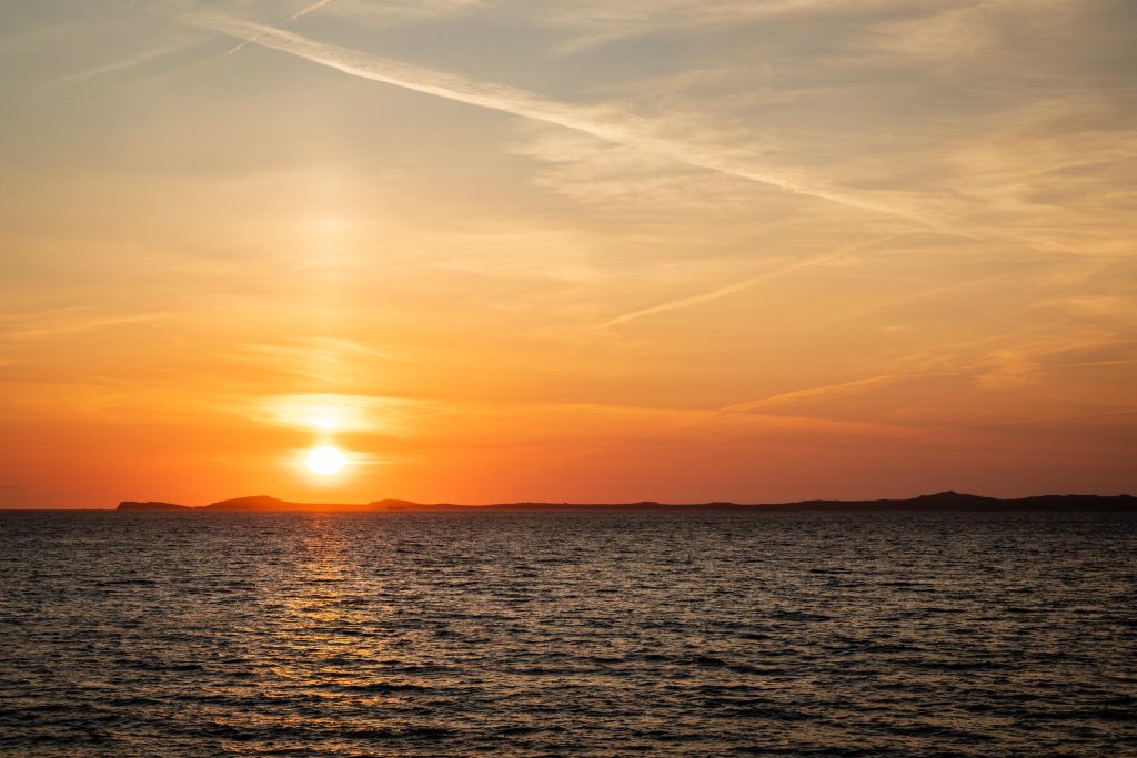 A golden summer sunset settles over the Pembrokeshire coast, Wales – view 2