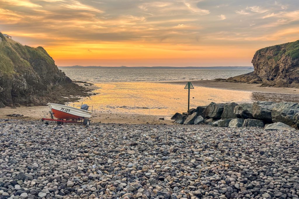 Little Haven Beach is caught in warm evening light as the tide recedes, Wales – view 2
